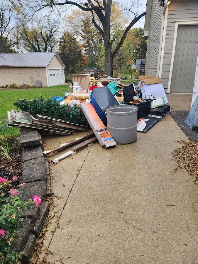 Dumpster being loaded with debris for 10 Yard Dumpster Rental in Kaunakakai